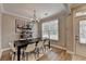 Charming dining room featuring a black table, elegant chandelier, and shelf decor at 1203 Penhurst Way, Lawrenceville, GA 30043