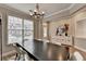 Charming dining room featuring hard wood floors, an elegant chandelier, and a large window at 1203 Penhurst Way, Lawrenceville, GA 30043