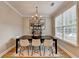 Charming dining room featuring a black table, elegant chandelier, and neutral rug at 1203 Penhurst Way, Lawrenceville, GA 30043