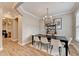 Charming dining room featuring a view into the living area with hard wood floors and neutral walls at 1203 Penhurst Way, Lawrenceville, GA 30043