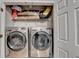 Laundry area includes front-loading washer and dryer, storage shelf, and a door at 1203 Penhurst Way, Lawrenceville, GA 30043