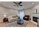 Cozy living room with a fireplace, comfortable seating, and a ceiling fan at 1203 Penhurst Way, Lawrenceville, GA 30043