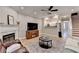 Inviting living room featuring a fireplace, television, and open access to the kitchen at 1203 Penhurst Way, Lawrenceville, GA 30043
