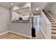 Bright living room with wood floors, white cabinets and stainless appliances at 1203 Penhurst Way, Lawrenceville, GA 30043