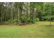 Expansive backyard with mature trees and lush greenery, offering a private and serene outdoor space at 155 Redspire Ln, Fayetteville, GA 30215