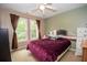 Cozy bedroom features two large windows, neutral paint, and a ceiling fan at 155 Redspire Ln, Fayetteville, GA 30215