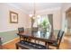 Cozy dining area with a dark wood table and ample natural light creating a warm atmosphere at 155 Redspire Ln, Fayetteville, GA 30215
