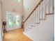 Grand foyer with hardwood floors, staircase, and a decorative door at 155 Redspire Ln, Fayetteville, GA 30215