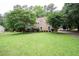 Spacious front yard and two-story home featuring manicured landscaping at 155 Redspire Ln, Fayetteville, GA 30215