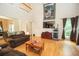 Bright living room featuring hardwood floors, a fireplace, and a view of the upper level at 155 Redspire Ln, Fayetteville, GA 30215
