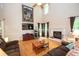 Inviting living room with hardwood floors, a fireplace, and large windows filling the space with light at 155 Redspire Ln, Fayetteville, GA 30215