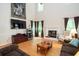 Bright living room features a fireplace, hardwood floors, and large windows at 155 Redspire Ln, Fayetteville, GA 30215