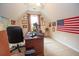 Inviting home office featuring a writing desk, an American flag, and ample natural light at 155 Redspire Ln, Fayetteville, GA 30215