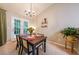 Dining area featuring a table setting for four, a chandelier, and a door leading to the outside at 3318 Freedom Lndg, Kennesaw, GA 30144