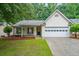 Charming one-story home with a well-manicured lawn, attached garage and an inviting front porch at 3318 Freedom Lndg, Kennesaw, GA 30144