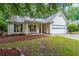 Charming home featuring a covered porch and well-manicured landscaping at 3318 Freedom Lndg, Kennesaw, GA 30144