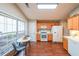 Bright kitchen with wood cabinets, white appliances, and a breakfast nook area with large windows at 3318 Freedom Lndg, Kennesaw, GA 30144
