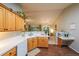 Well-lit kitchen with wood cabinets, white countertops and views of the living and dining areas at 3318 Freedom Lndg, Kennesaw, GA 30144