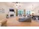 Spacious living room with a fireplace, a large window, a sofa and an adjacent dining area at 3318 Freedom Lndg, Kennesaw, GA 30144