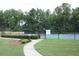 A view of community tennis courts surrounded by lush landscaping and fencing at 3318 Freedom Lndg, Kennesaw, GA 30144