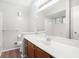Bathroom with wood vanity, white countertop and white tile surround at 3448 Great Meadows Ct, Lithonia, GA 30038