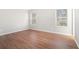 This bedroom features updated flooring and two windows for natural light at 3448 Great Meadows Ct, Lithonia, GA 30038