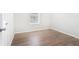 This bedroom features updated flooring and a window for natural light at 3448 Great Meadows Ct, Lithonia, GA 30038