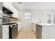 Kitchen featuring stainless steel appliances, white cabinets and tile flooring at 3448 Great Meadows Ct, Lithonia, GA 30038