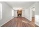 Living room with a stone fireplace, wood floors, and a view into another room at 3448 Great Meadows Ct, Lithonia, GA 30038