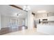 Open-concept living and kitchen area featuring stainless appliances, breakfast bar and tile floors at 3448 Great Meadows Ct, Lithonia, GA 30038