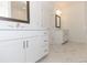Bright bathroom with double sink, marble tile floor, featuring white cabinets and modern design at 709 Dodd Ln # 165, Buford, GA 30518