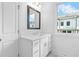 Bathroom features a vanity with a mirror, drawers, and a window at 709 Dodd Ln # 165, Buford, GA 30518