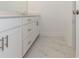 Bright bathroom with double sink, marble tile floor, featuring white cabinets and modern design at 709 Dodd Ln # 165, Buford, GA 30518