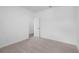 A carpeted bedroom with white walls and a door at 709 Dodd Ln # 165, Buford, GA 30518