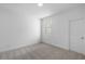 A carpeted bedroom with white walls and a window at 709 Dodd Ln # 165, Buford, GA 30518