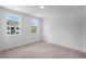 A carpeted bedroom with two windows at 709 Dodd Ln # 165, Buford, GA 30518