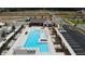 Aerial view of community pool with surrounding lounge chairs, ample parking, and a clubhouse nearby at 709 Dodd Ln # 165, Buford, GA 30518