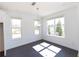 Bright dining room with dark wood floors, a modern chandelier, and natural light from two large windows at 709 Dodd Ln # 165, Buford, GA 30518