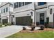 This townhome features a two-car garage, front door, and manicured landscape at 709 Dodd Ln # 165, Buford, GA 30518
