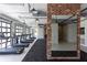 Well-equipped gym featuring rows of treadmills, brick accent wall, and large mirrors at 709 Dodd Ln # 165, Buford, GA 30518