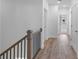 Upstairs hallway featuring wood-look floors and access to rooms at 709 Dodd Ln # 165, Buford, GA 30518