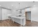 Spacious kitchen featuring a large island, white cabinets, and stainless steel appliances at 709 Dodd Ln # 165, Buford, GA 30518