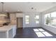 Bright open-concept kitchen with stainless steel appliances and adjacent dining area at 709 Dodd Ln # 165, Buford, GA 30518