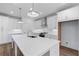 Bright kitchen features white cabinets, stainless steel appliances, and a large center island with a sink at 709 Dodd Ln # 165, Buford, GA 30518