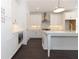 Modern kitchen with stainless steel appliances, an island with sink, and white cabinetry at 709 Dodd Ln # 165, Buford, GA 30518