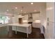 Bright kitchen featuring white cabinets, stainless steel appliances, and a large island with quartz countertop at 709 Dodd Ln # 165, Buford, GA 30518