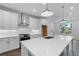 Bright kitchen featuring a large island, modern stainless steel appliances and white cabinetry at 709 Dodd Ln # 165, Buford, GA 30518