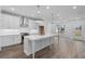 This spacious kitchen features an island, modern appliances, and wood floors at 709 Dodd Ln # 165, Buford, GA 30518