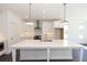 Stylish kitchen featuring a large island with white countertops, stainless steel appliances, and ample cabinet space at 709 Dodd Ln # 165, Buford, GA 30518
