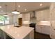 Bright kitchen featuring a spacious island, stainless steel appliances, and white cabinets at 709 Dodd Ln # 165, Buford, GA 30518